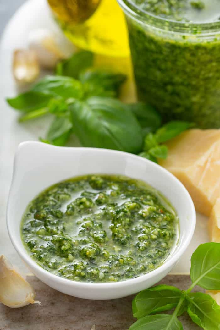 Shallow white bowl filled with fresh basil pesto