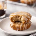 Two zucchini cookies stacked on a white plate. A bite has been taken out of the top cookie