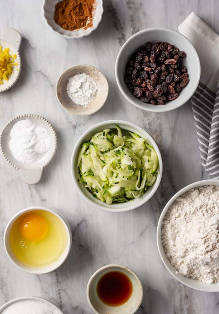 Ingredients for zucchini cookies arranged on a marble countertop