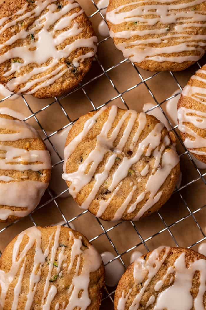 Close-up of freshly glazed zucchini cookies set on a wire cooling rack