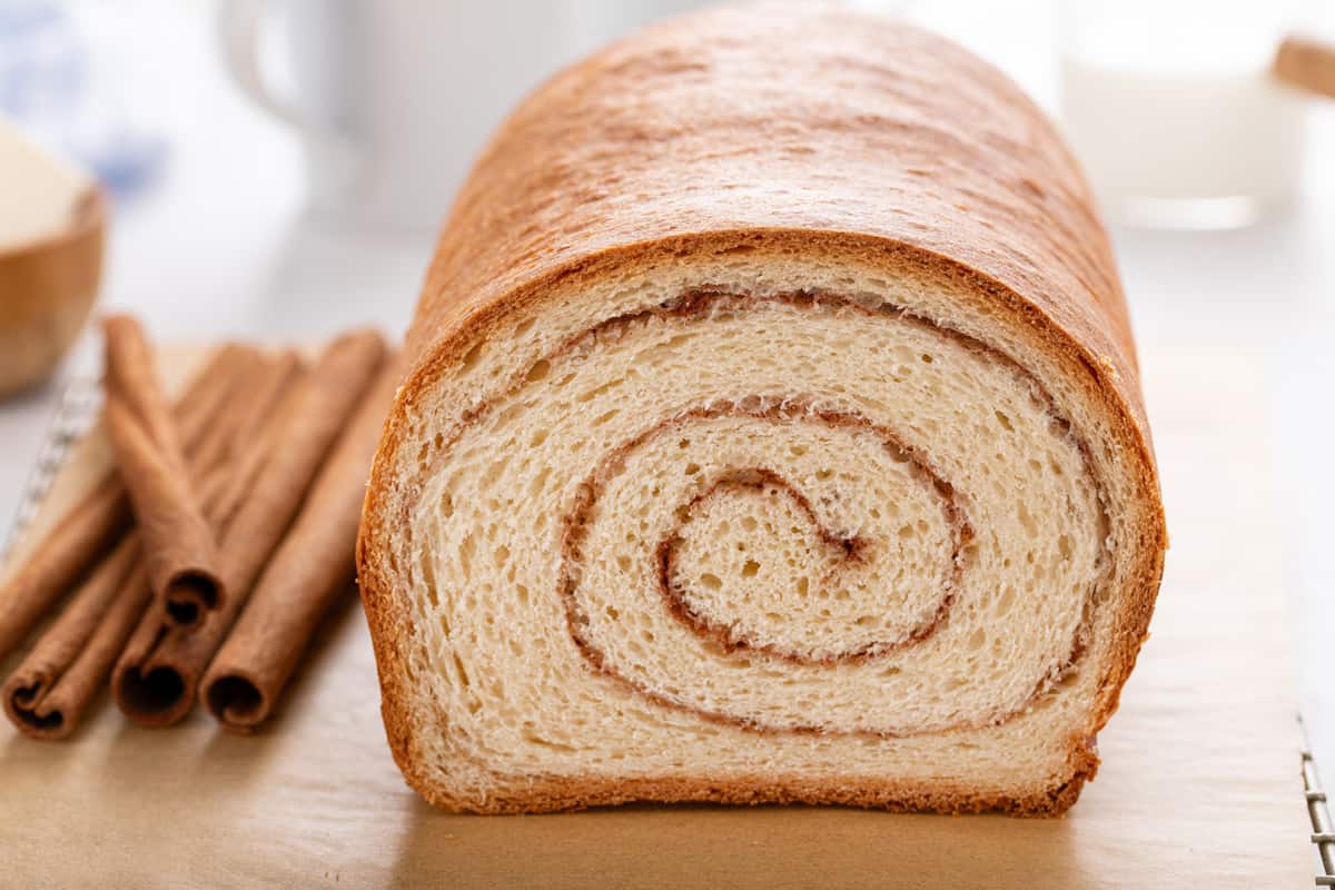 Cross-section of a sliced loaf of cinnamon swirl bread to show the swirl.