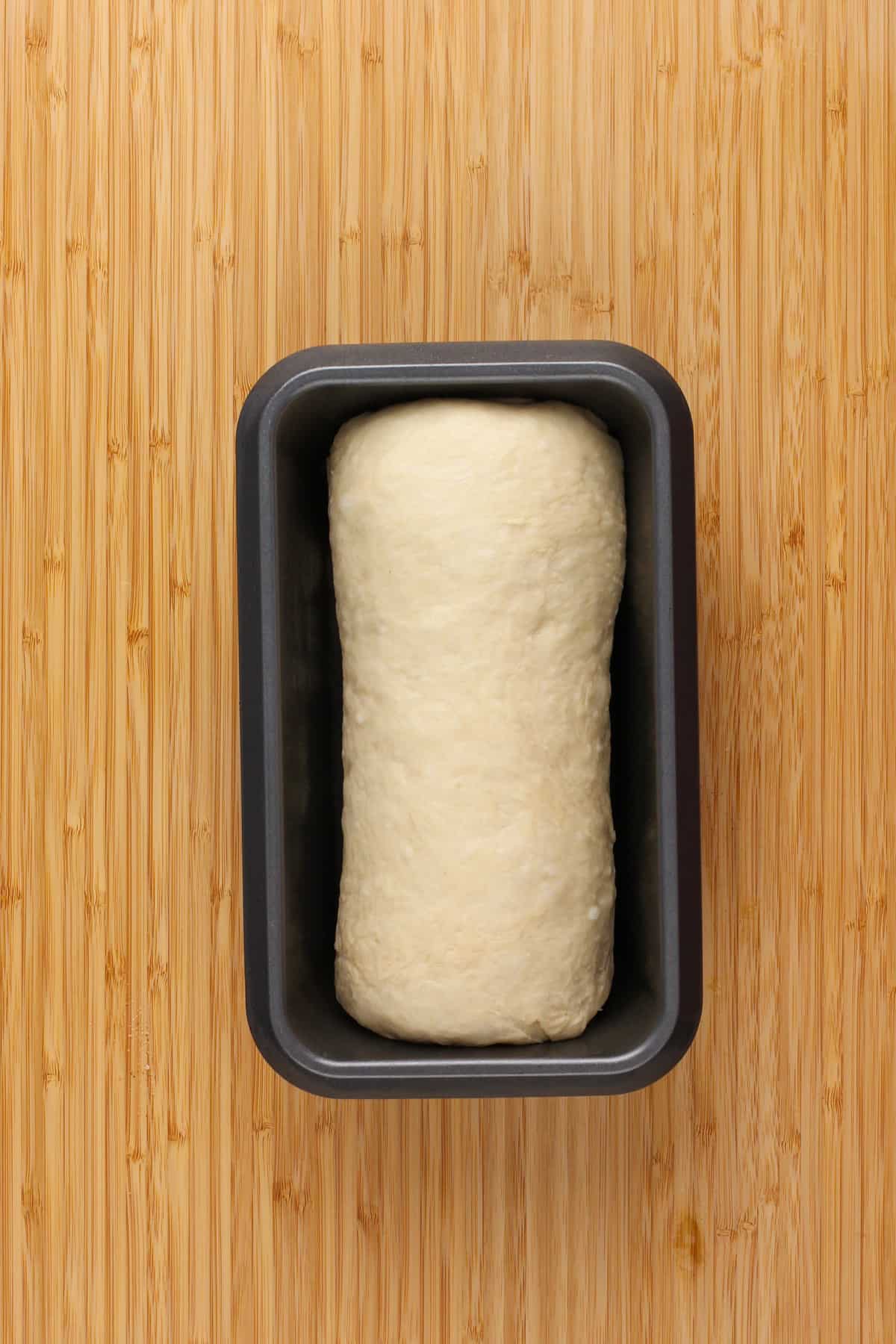 Proofed loaf of cinnamon swirl bread ready to go in the oven.