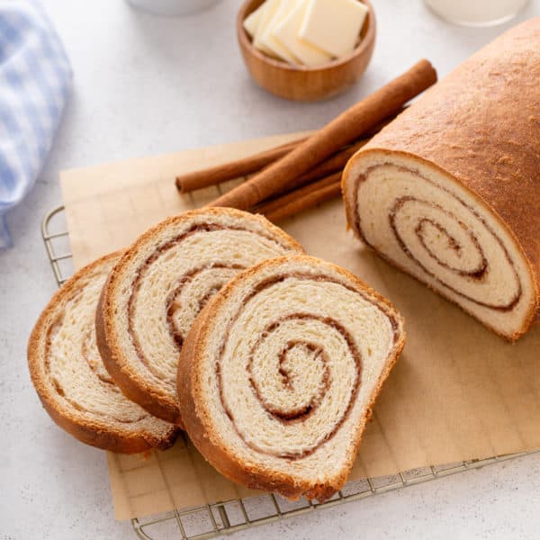 Slices of cinnamon swirl bread on a piece of parchment paper.