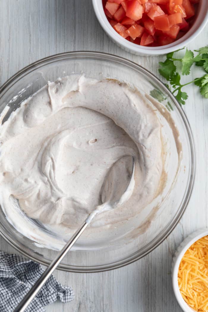 Sour cream, cream cheese, and spices mixed in a bowl.