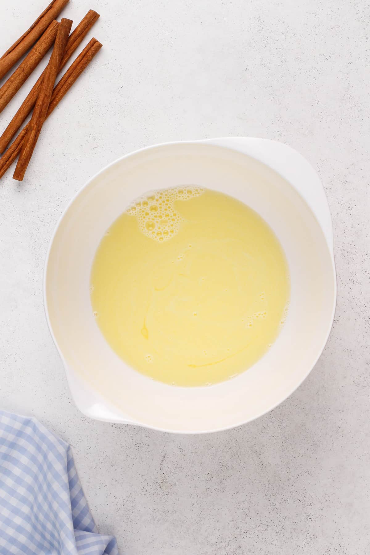 Warmed milk and butter in a white bowl.