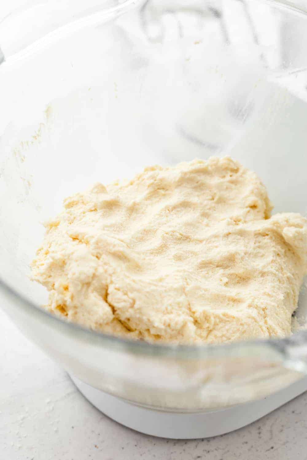 Shortbread crust for apple pie bars in a glass mixing bowl