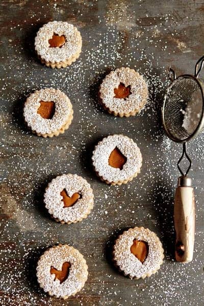 Overhead photo of Linzer cookies with different fall cutouts sprinkled with powdered sugar