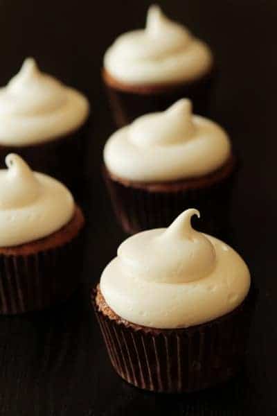 Close up of pumpkin spice cupcakes with a black background