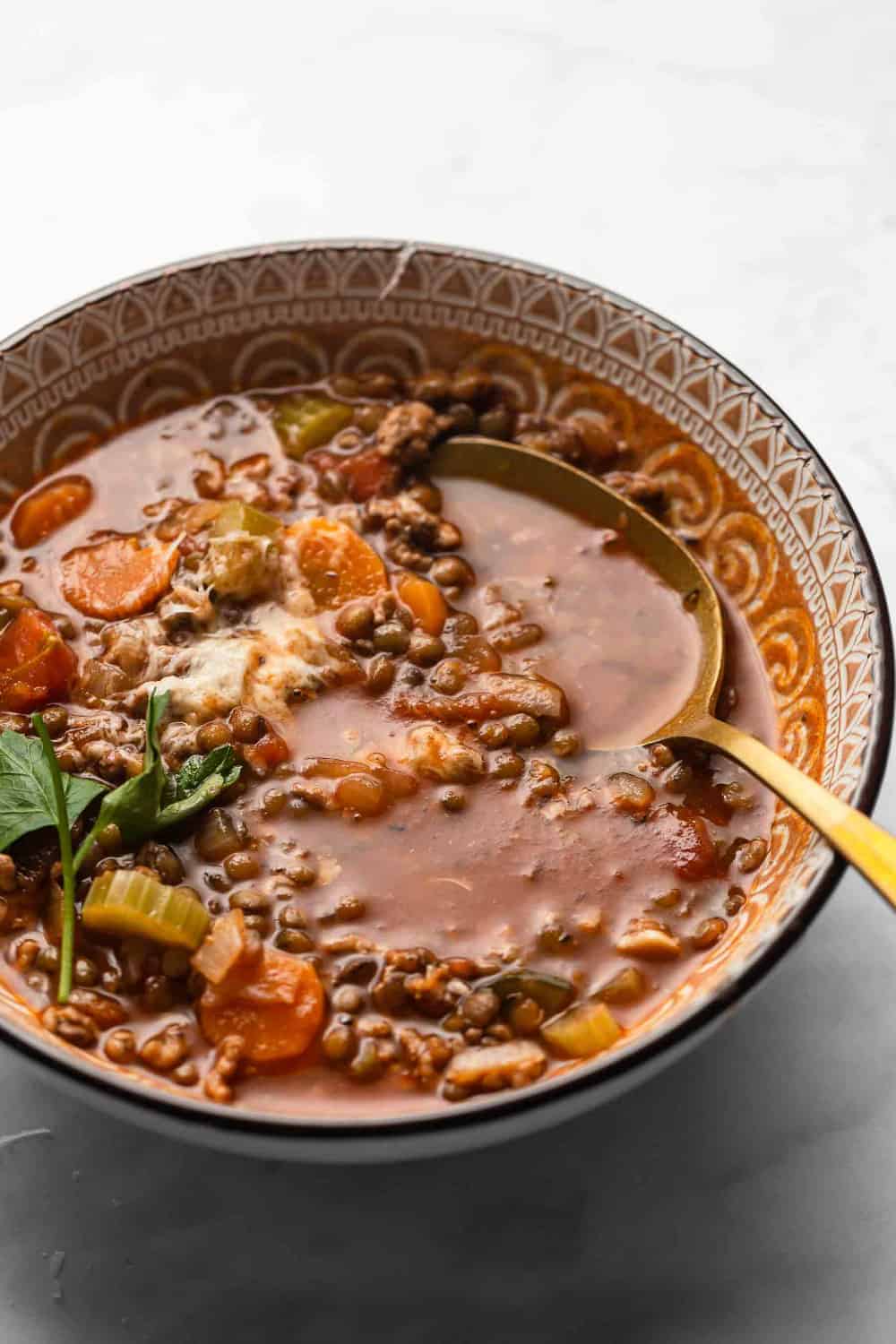 Spoon in a bowl of Sausage and Lentil Soup