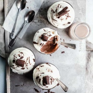 Homemade chocolate pudding in 4 small serving dishes, with several bites taken out of the middle dish