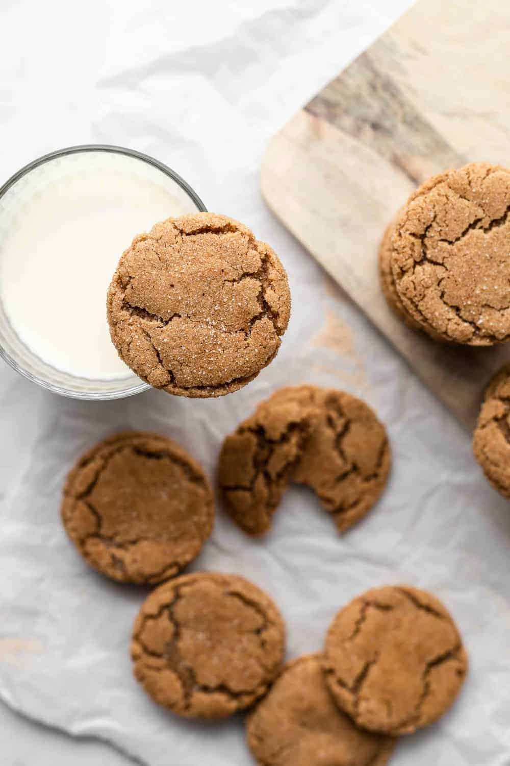 Chai sugar cookie balanced on the edge of a glass of milk