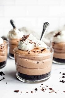 Close up of mini no bake nutella cheesecake with oreo crust in a glass ramekin