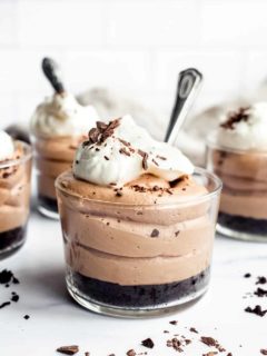 Close up of mini no bake nutella cheesecake with oreo crust in a glass ramekin