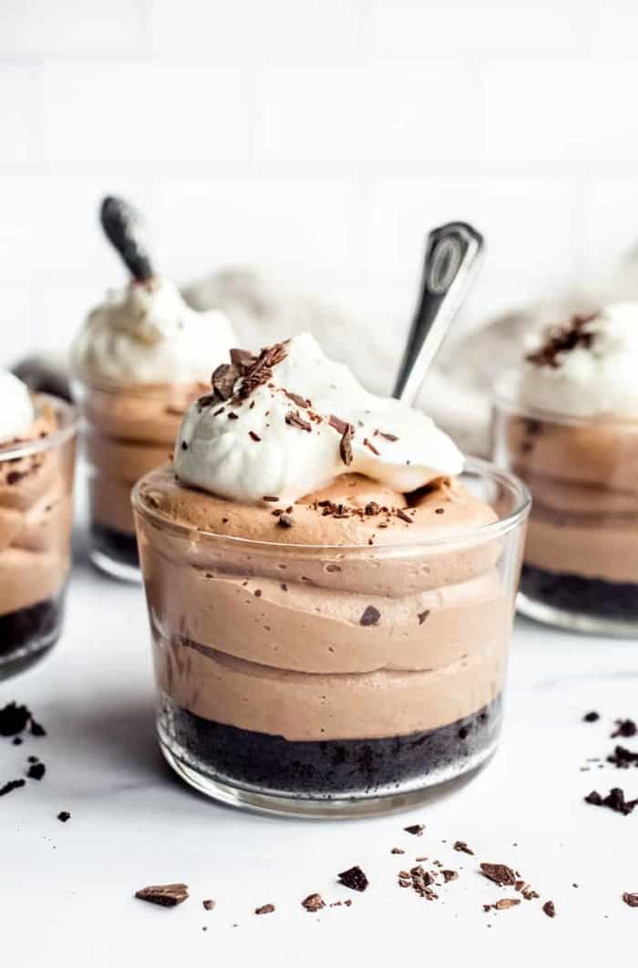 Close up of mini no bake nutella cheesecake with oreo crust in a glass ramekin