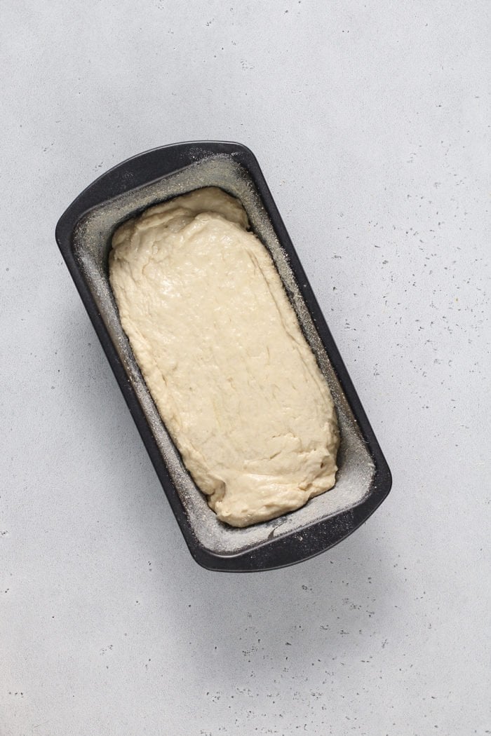 Dough for english muffin bread in a loaf pan, ready to rise