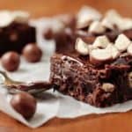 A Whopper brownie on parchment paper next to a spoon