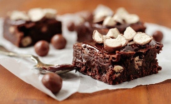 A Whopper brownie on parchment paper next to a spoon