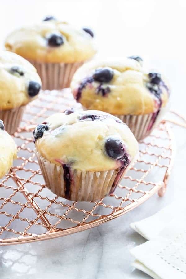 Blueberry Doughnut Muffins are topped with a sweet and tangy lemon glaze.  This is going to be your new favorite muffin recipe!