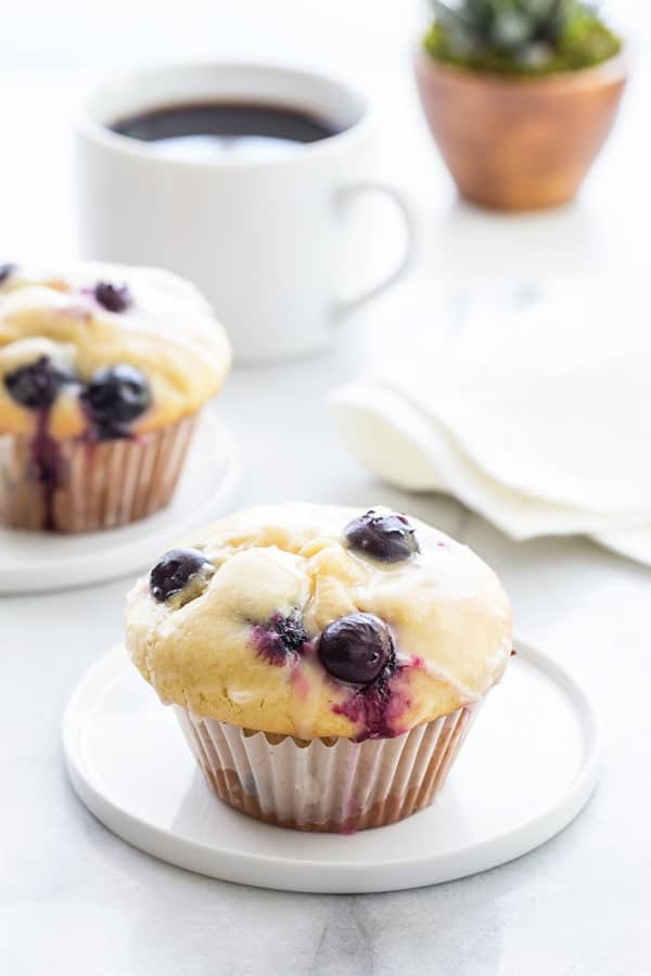 Blueberry Doughnut Muffins are topped with a sweet and tangy lemon glaze.  Your family and friends will be begging you for this recipe!