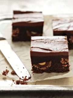 Nutella brownies cut, next to a knife on a baking sheet