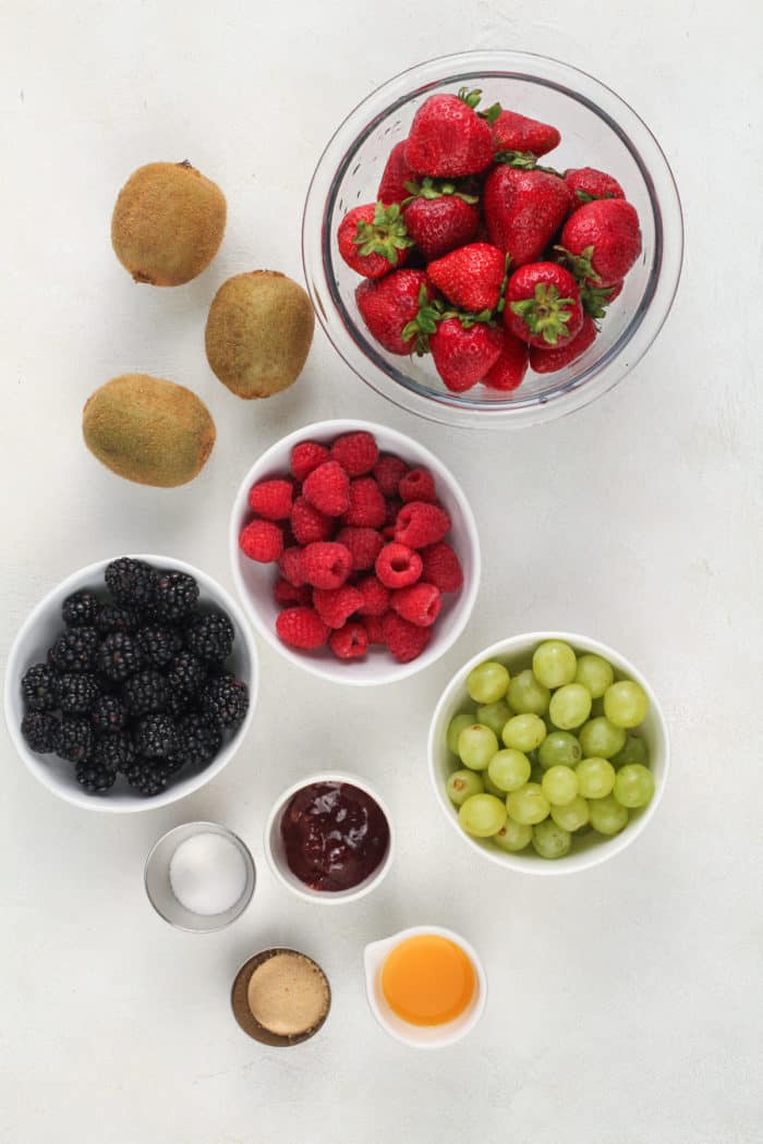 Fruit salsa ingredients arranged on a white countertop.