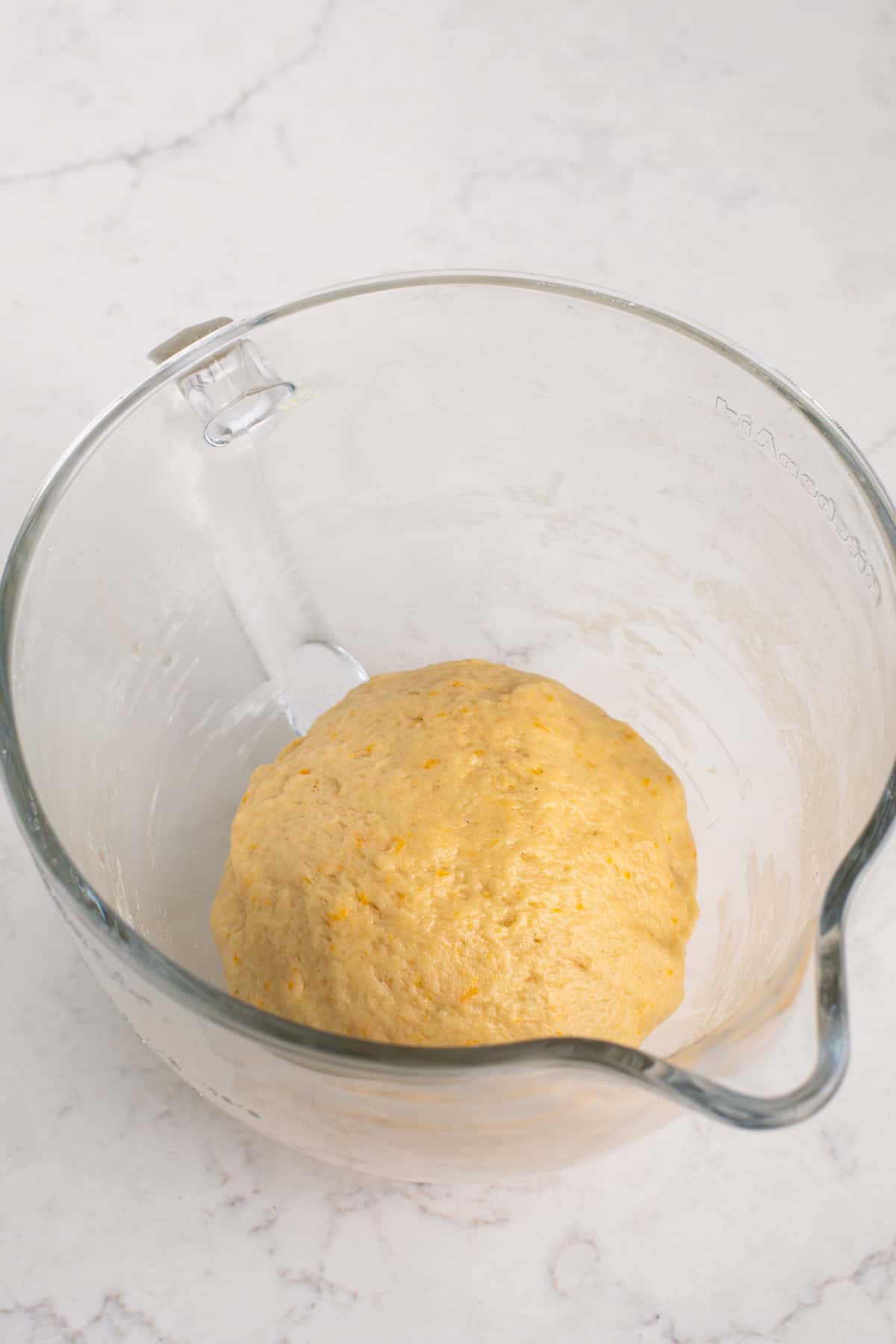 Kneaded orange roll dough, ready to rise.