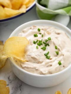 Potato chip in a bowl of french onion dip