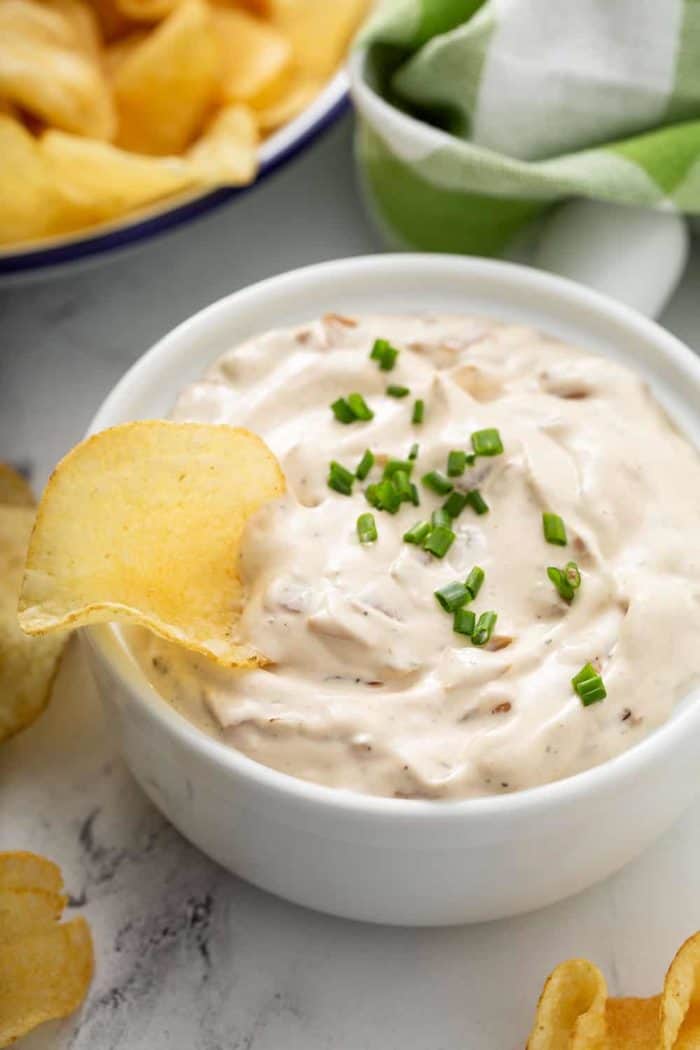 Potato chip in a bowl of french onion dip