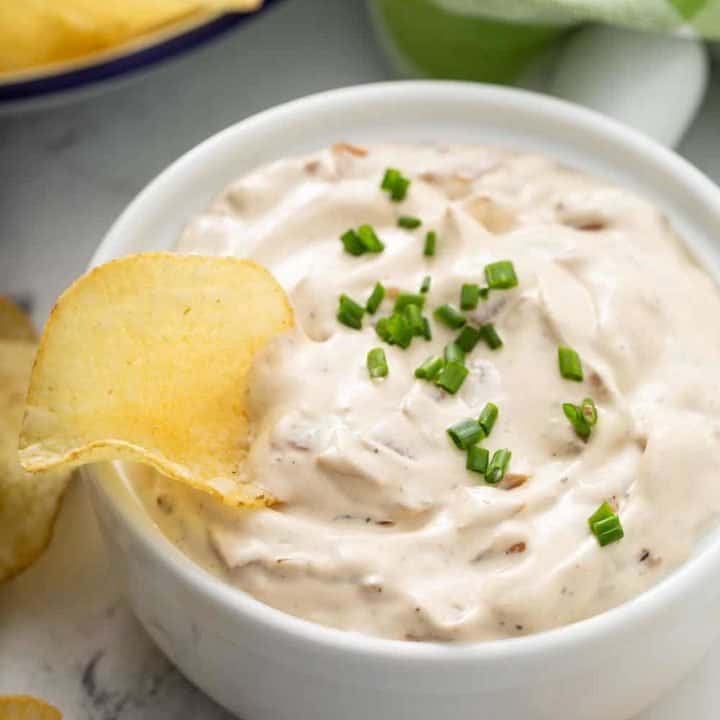 Potato chip in a bowl of french onion dip