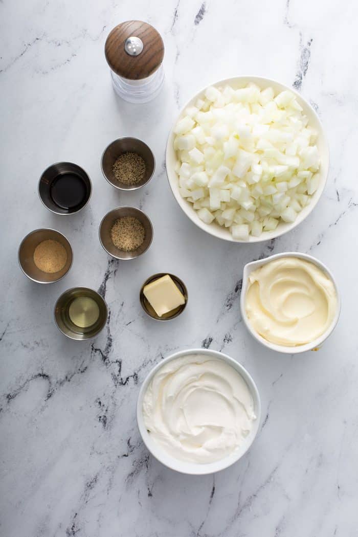 Ingredients for french onion dip arranged on a countertop