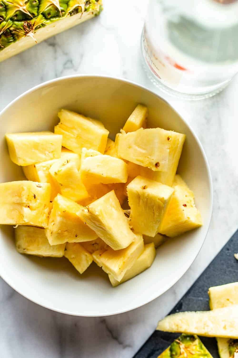 Diced pineapple in a white bowl