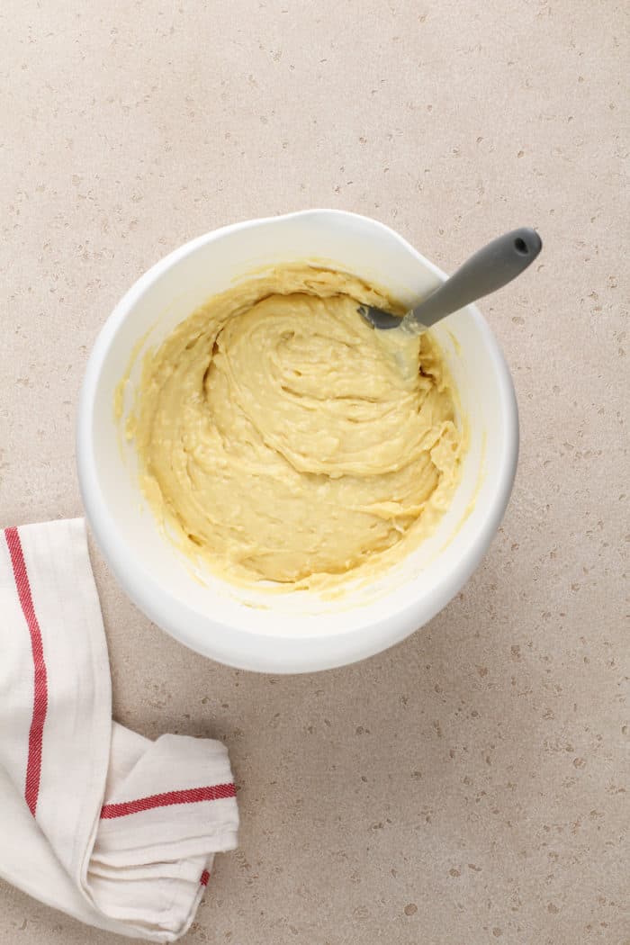 Coconut cupcake batter in a white mixing bowl.