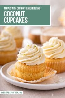 Unwrapped coconut cupcake on a white plate. More cupcakes are visible in the background. Text overlay includes recipe name.