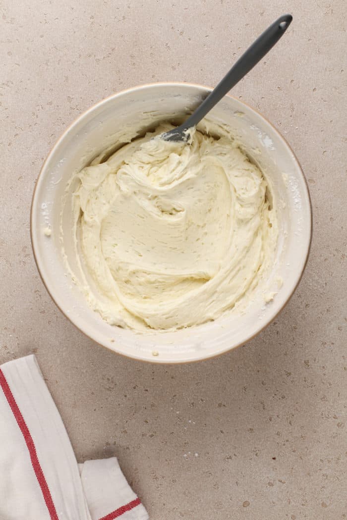 Coconut-lime frosting in a white mixing bowl.