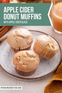 Three apple cider donut muffins arranged on a speckled plate. Text overlay includes recipe name.