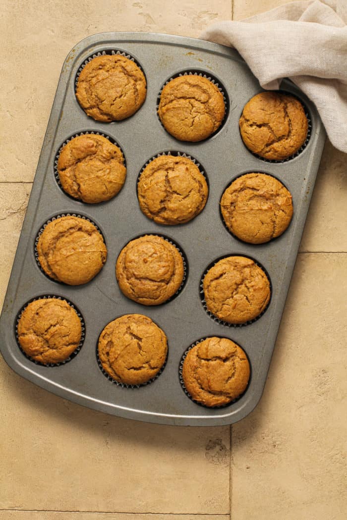 Baked pumpkin spice cupcakes in a muffin tin