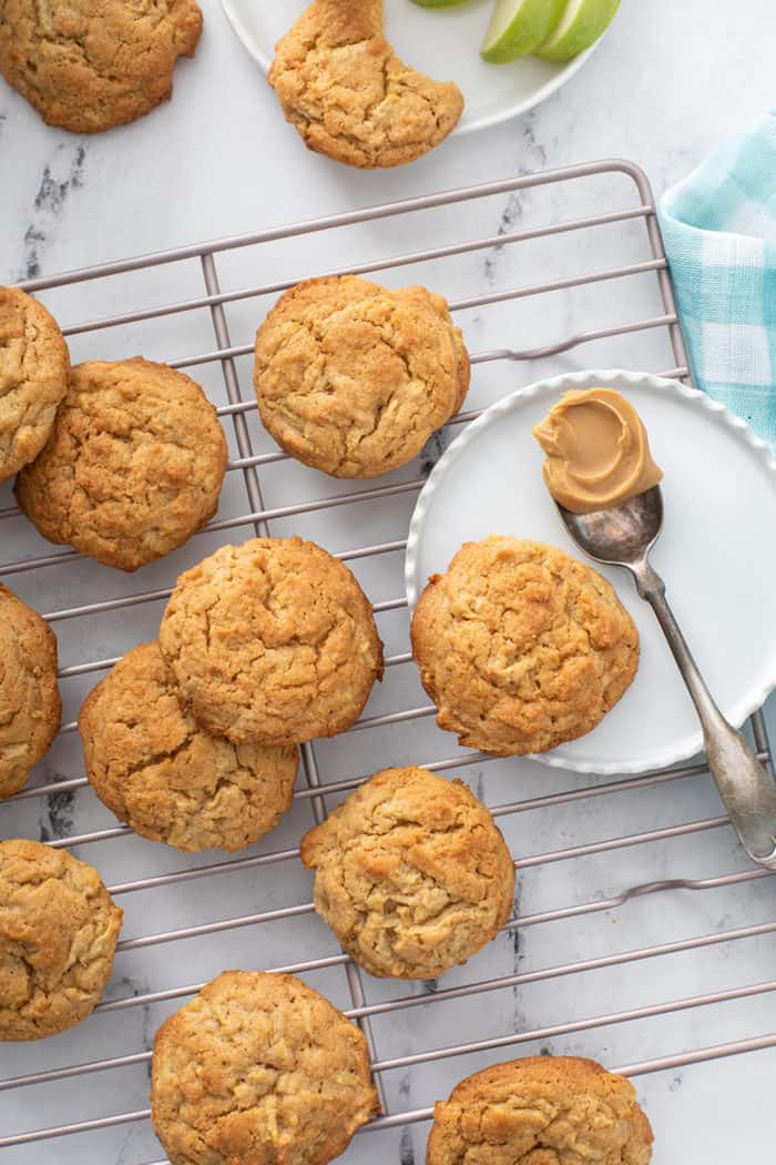 Apple peanut butter cookies scattered on a wire cooling rack