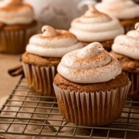 Frosted pumpkin spice cupcakes on a wire cooling rack