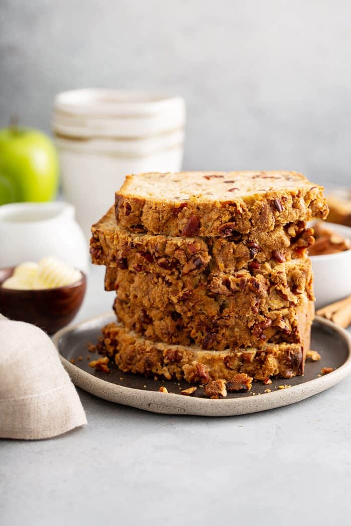 Five slices of apple pie bread stacked on a gray plate