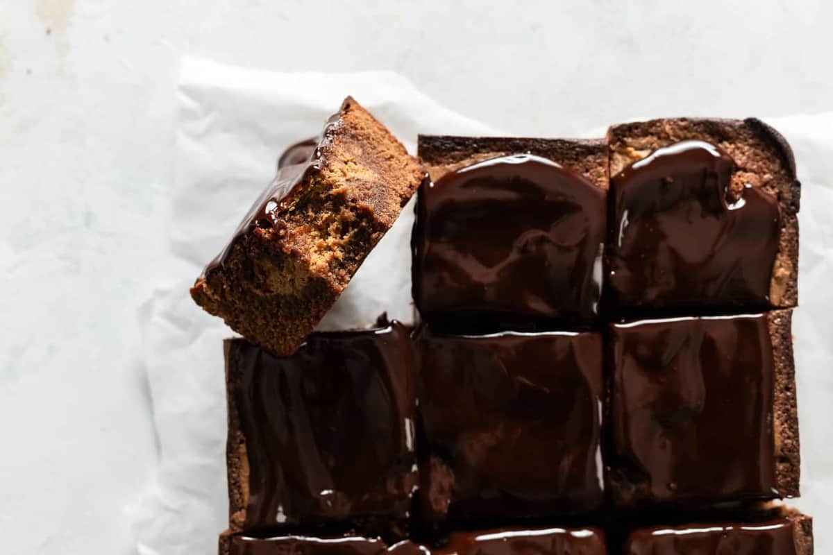 Pumpkin brownies sliced on a piece of parchment paper