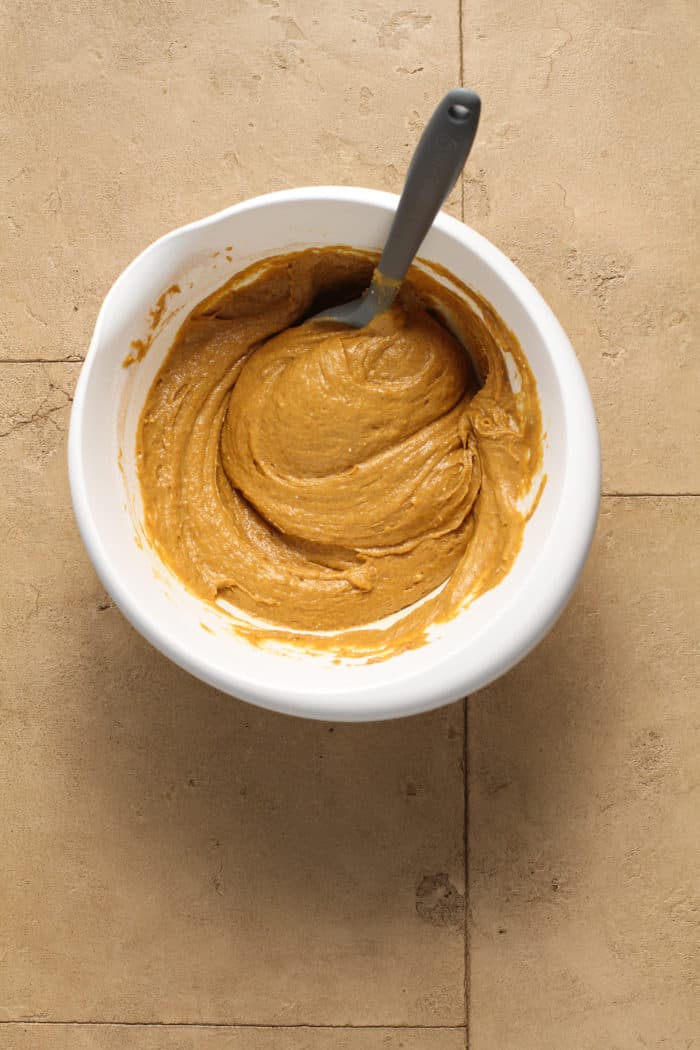 Pumpkin spice cupcake batter in a white bowl