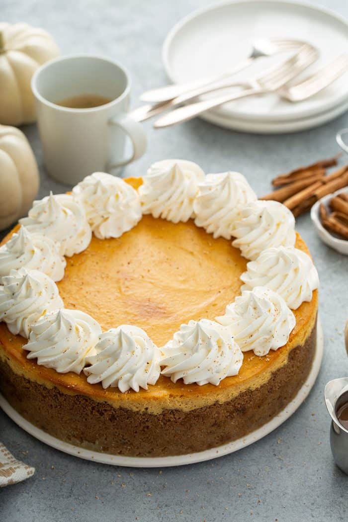 Baked and cooled pumpkin cheesecake garnished with whipped cream