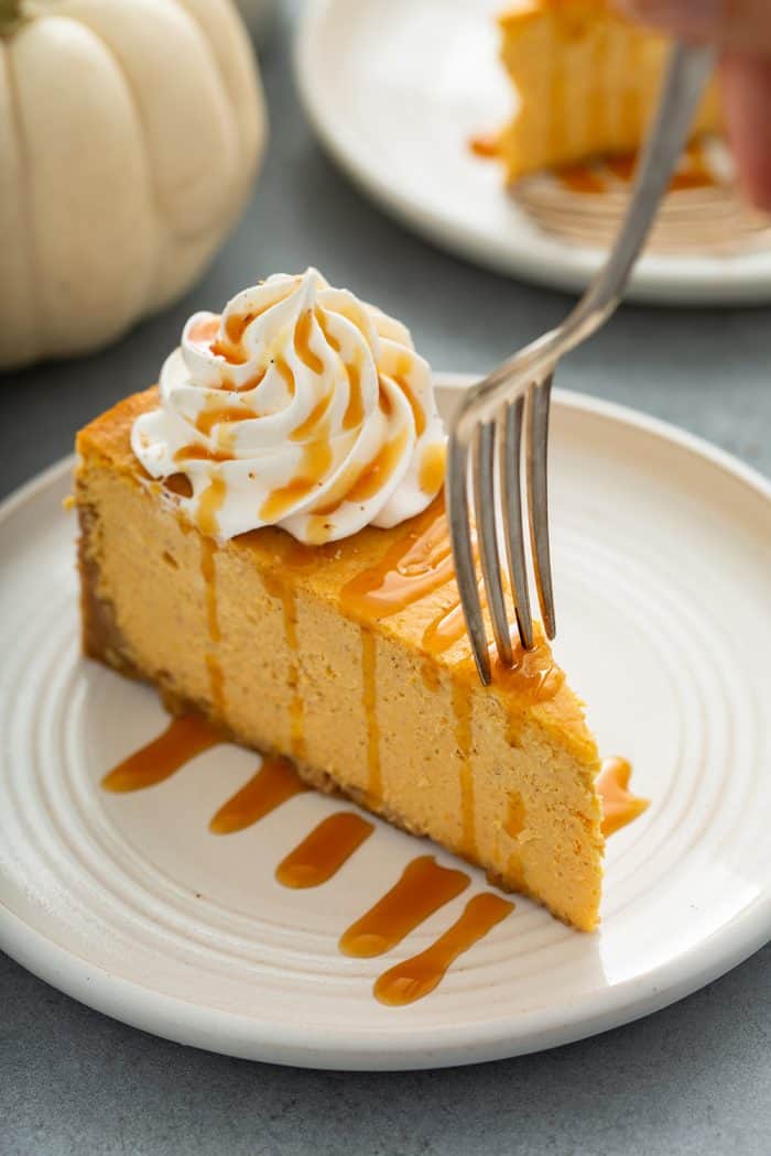 Fork about to take a bite of pumpkin cheesecake
