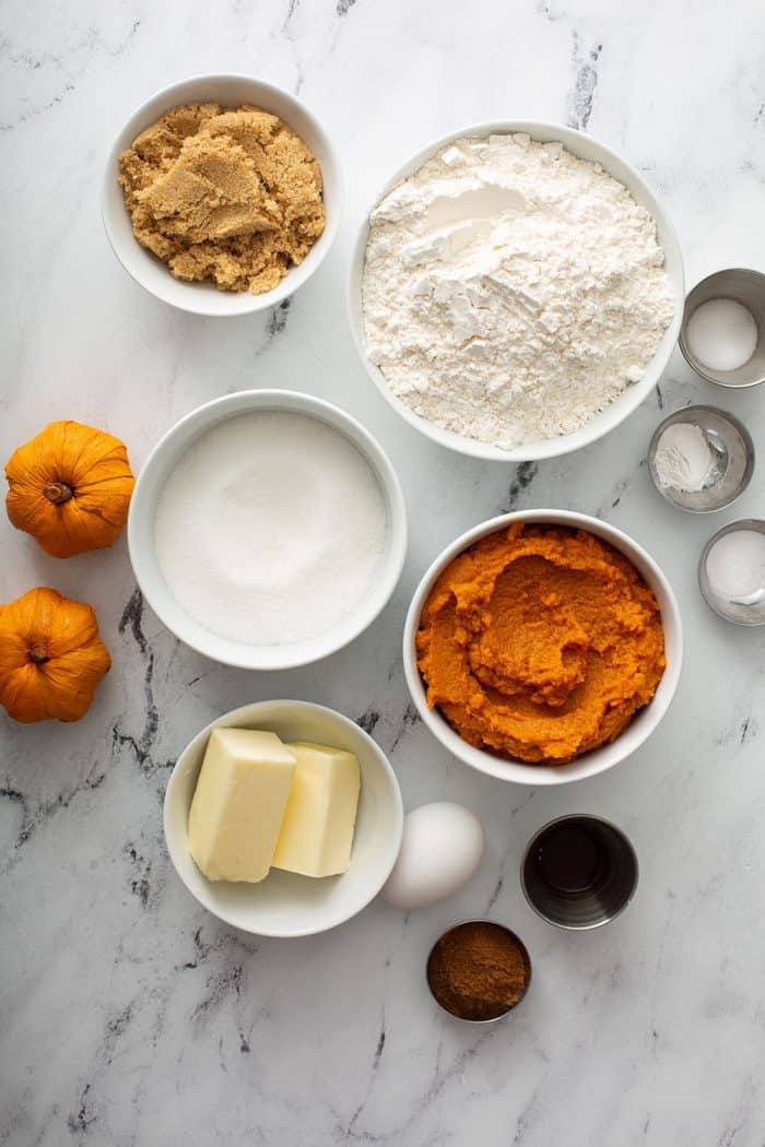 Pumpkin cookie ingredients on a marble counter