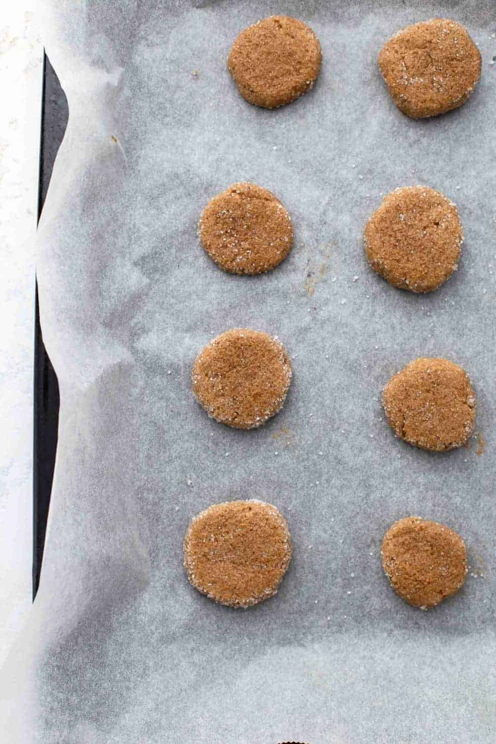 balls of Pumpkin molasses cookie dough rolled in sugar, ready to be baked