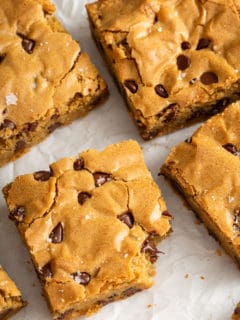 Cut Chocolate Chip Blondies on a piece of parchment paper