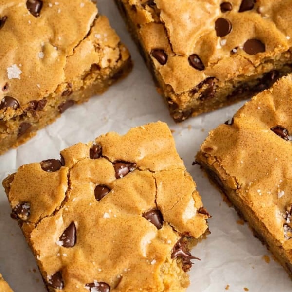 Cut Chocolate Chip Blondies on a piece of parchment paper