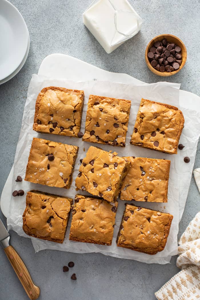 Cut chocolate chip blondies on a piece of parchment paper