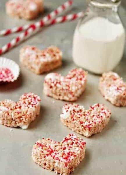 Heart shaped rice krispie treats with red and white sprinkles on top