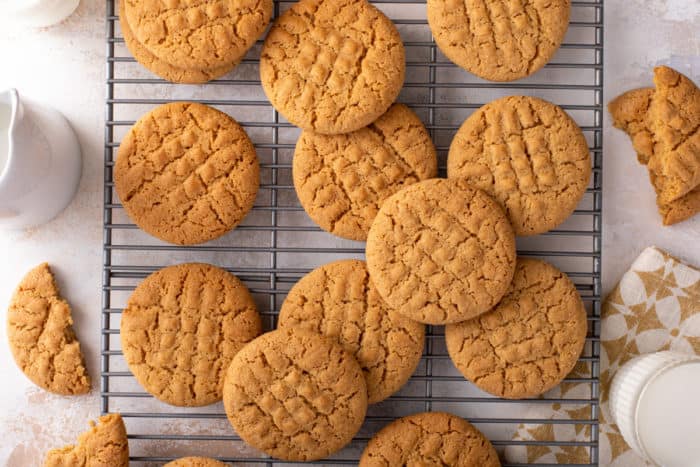 Honey peanut butter cookies scattered on a wire cooling rack.
